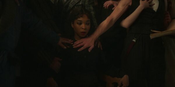 Claudia (Delaney Hayles) is encircled by multiple arms 