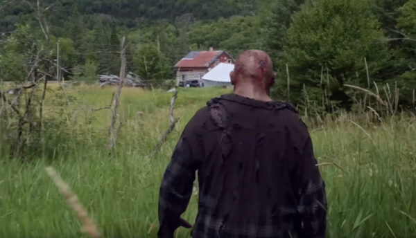 Johnny (Ry Barrett) approaches a farmhouse at the edge of a clearing