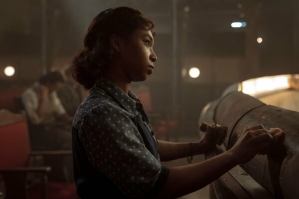 Claudia (Delainey Hayles) cleans a brass light on the stage