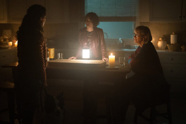 Claire Kelly (Holly A. Morris), Valeria Shanley (Diany Rodriguez),and Ellen Chenoweth (Kathy Baker) stand around a kitchen island with candles