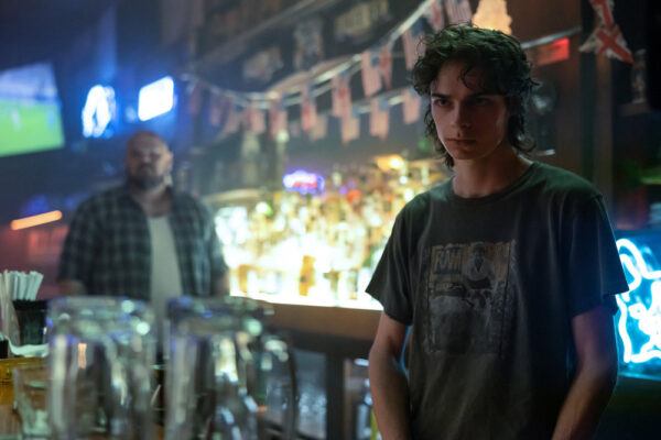 Jackson Kelly as Travis, manning a bar