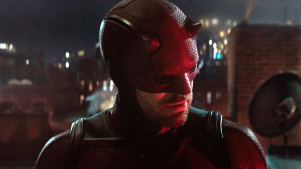 A close-up of Daredevil's face, his head cocked to the side, listening